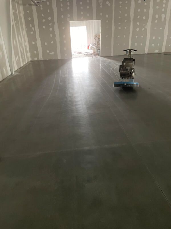 A machine is sitting on top of a concrete floor in a room.