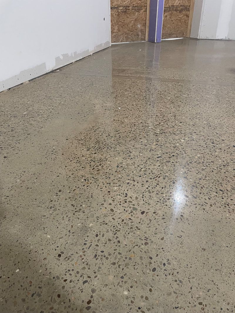 A close up of a shiny concrete floor in a room.