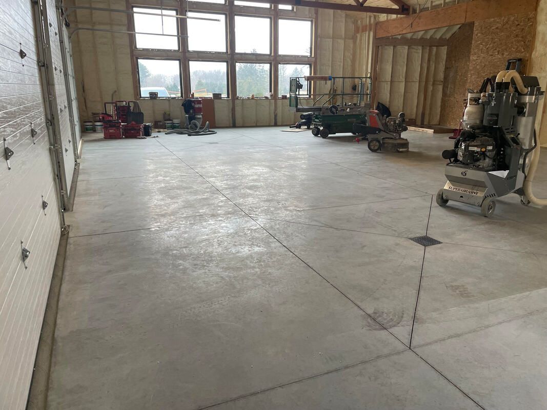 A large room with a lot of windows and machinery in it.