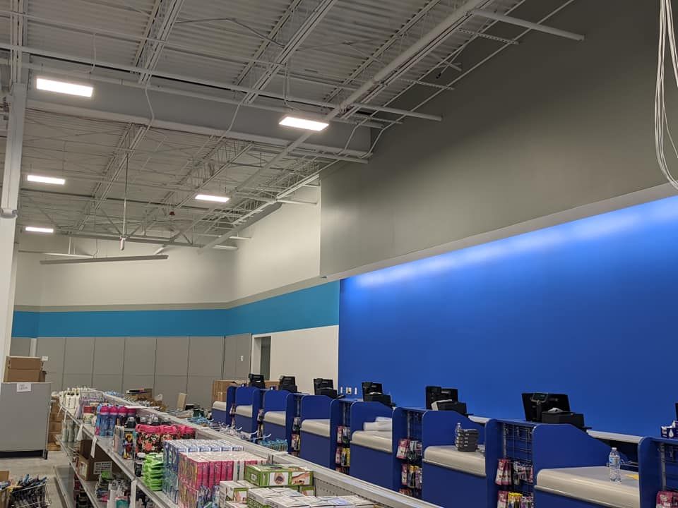 The inside of a store with blue walls and shelves.