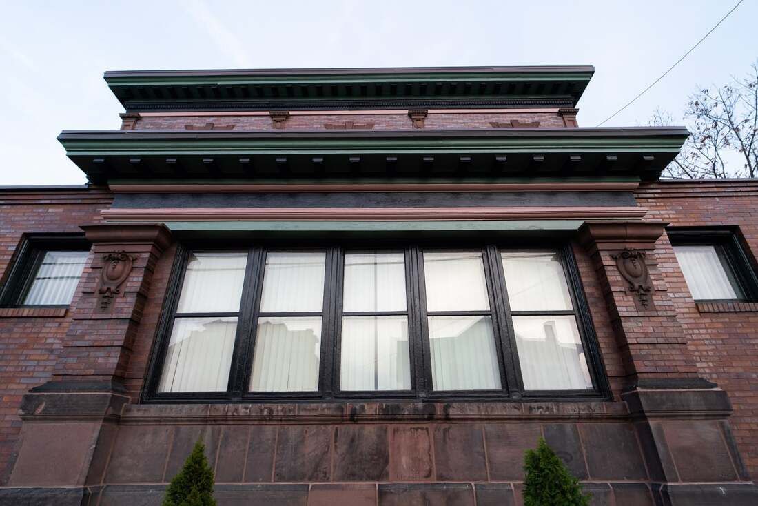 A large window on the side of a brick building.