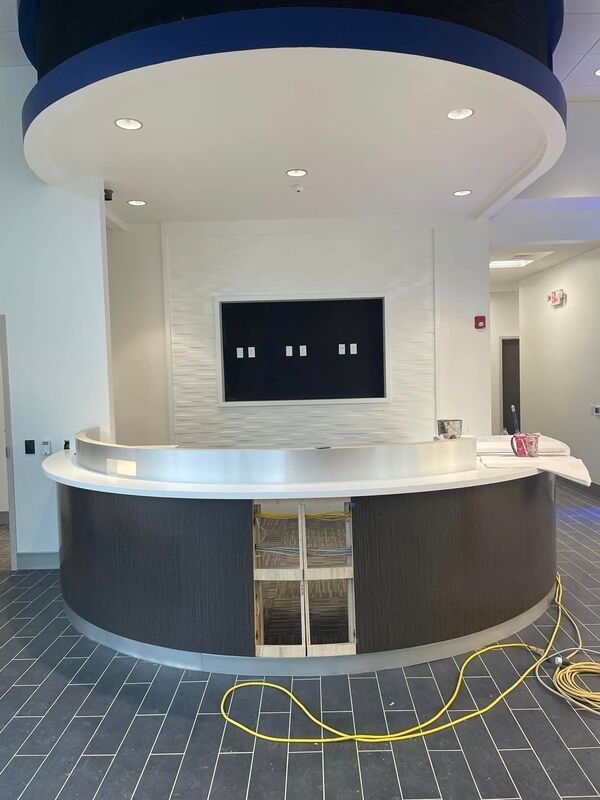 A round counter in a room with a tv on the wall.