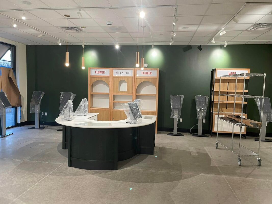 An empty room with a counter and shelves in it.