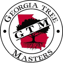 A circular logo featuring a red silhouette of Georgia with a black tree and its roots, overlaid with the text "G T M".