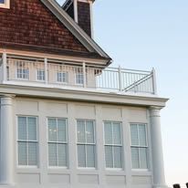 A large house with a balcony on top of it.