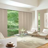 A living room filled with furniture and a large window.