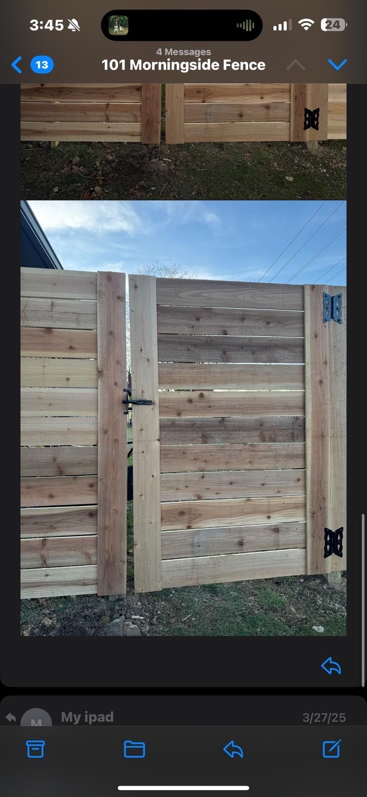 A picture of a wooden fence on a cell phone.