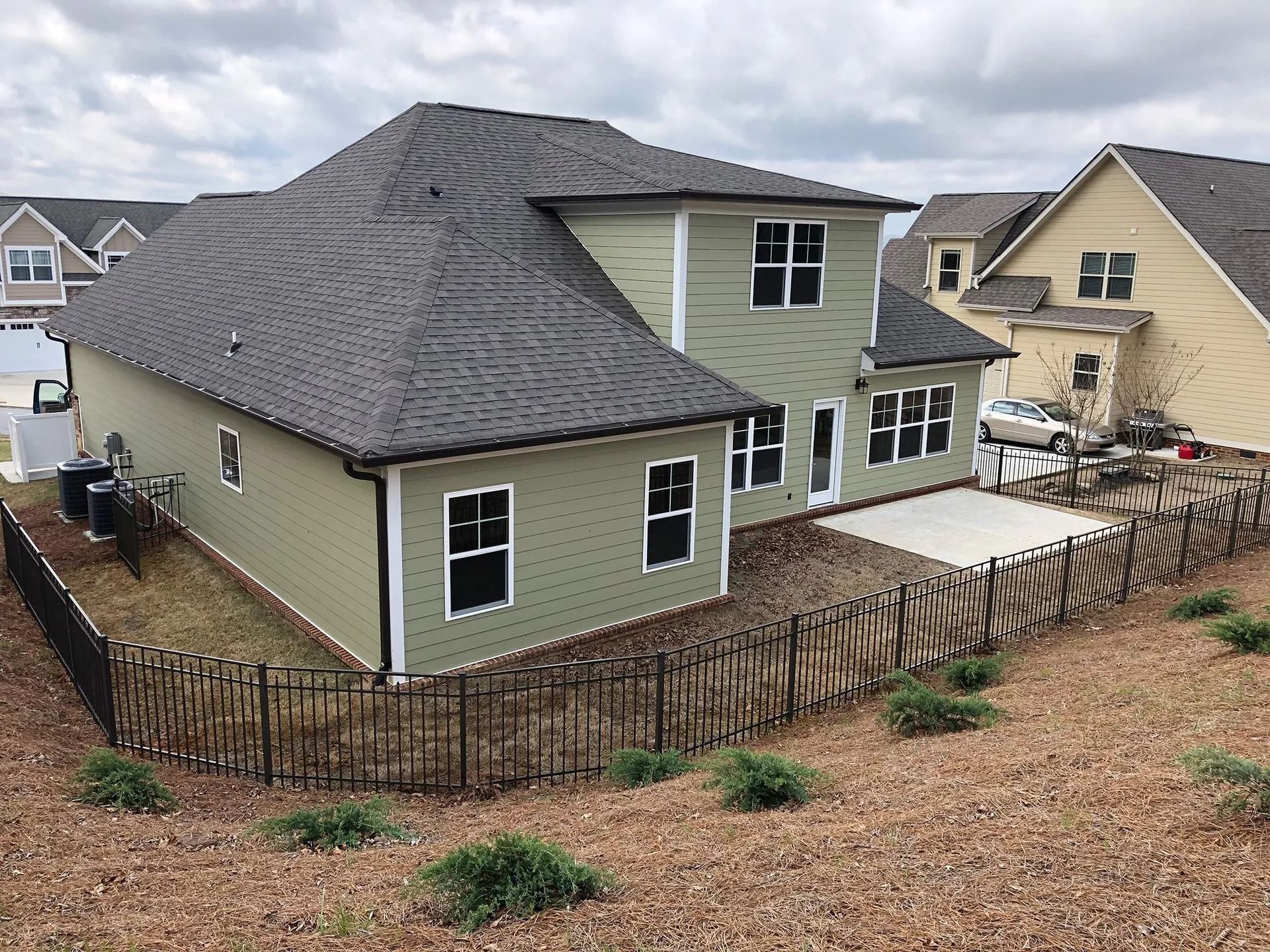 A house with a fence around it and a lot of windows
