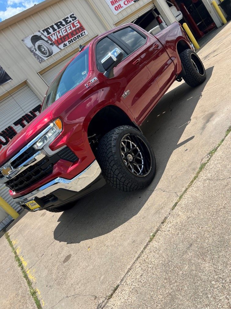 red truck with tires on and outside