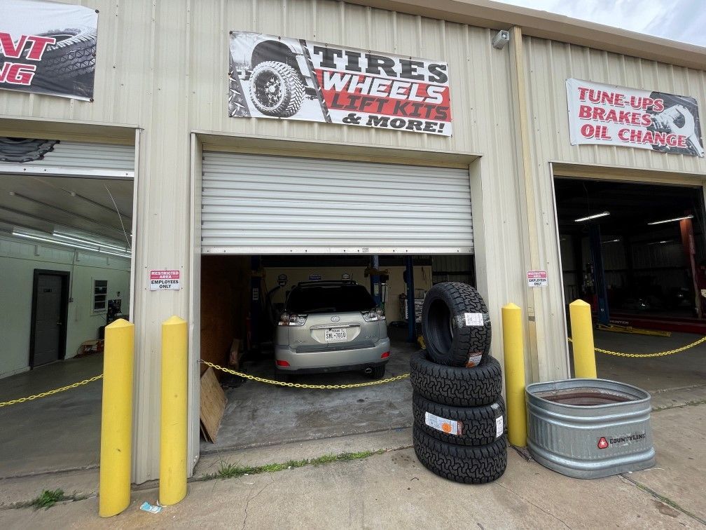 image with tires and vehicle inside car bay