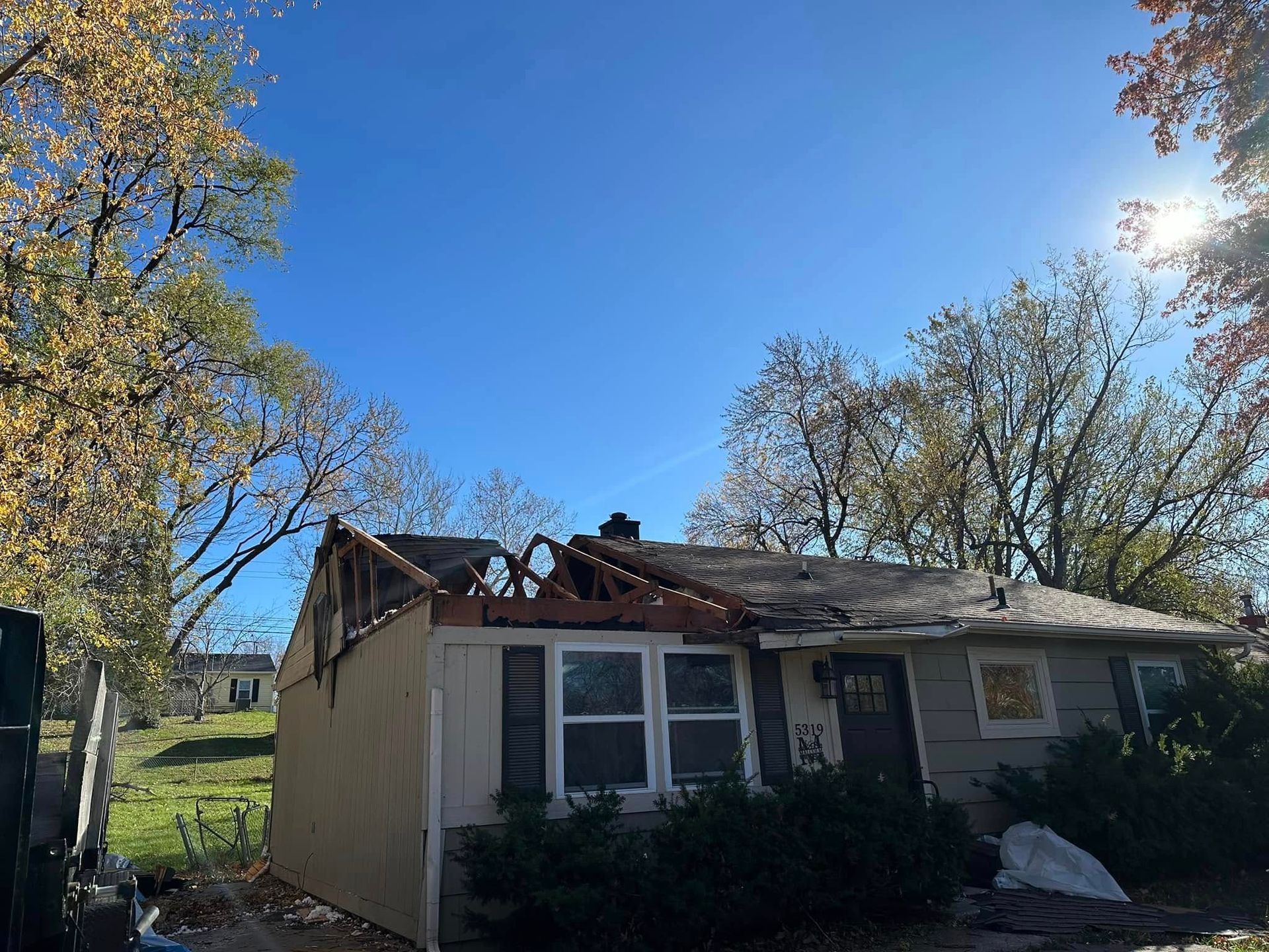 A house with a roof that has been damaged by a tornado.