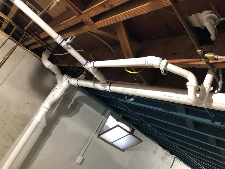 A room with a lot of pipes hanging from the ceiling