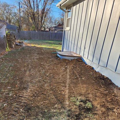 A house with a lot of dirt in front of it.