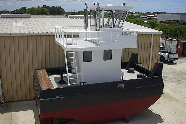 A large boat is parked in front of a building