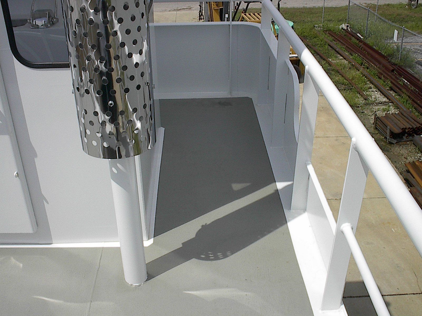 A white railing on the side of a boat