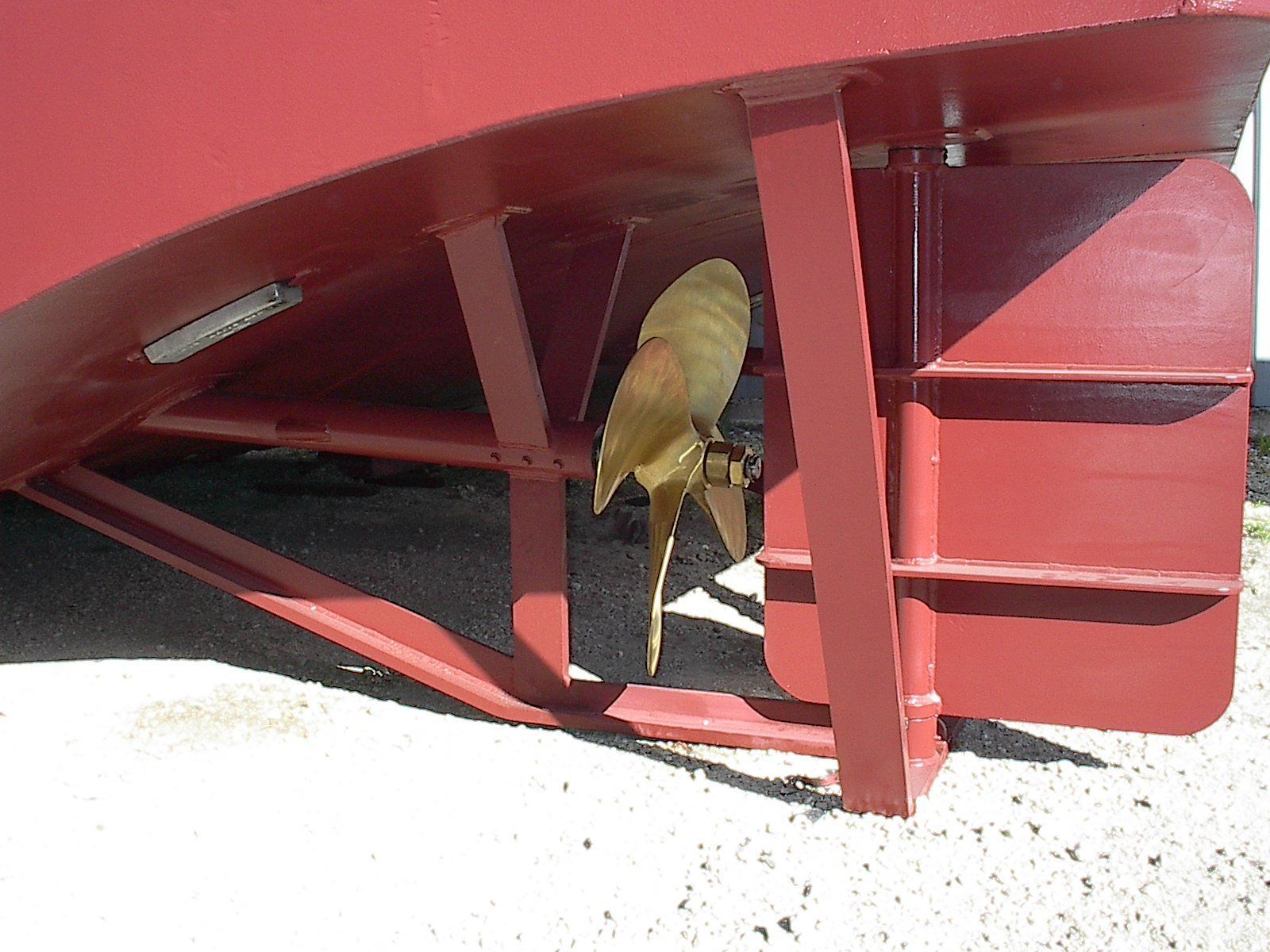 A close up of a boat propeller on the side of a boat