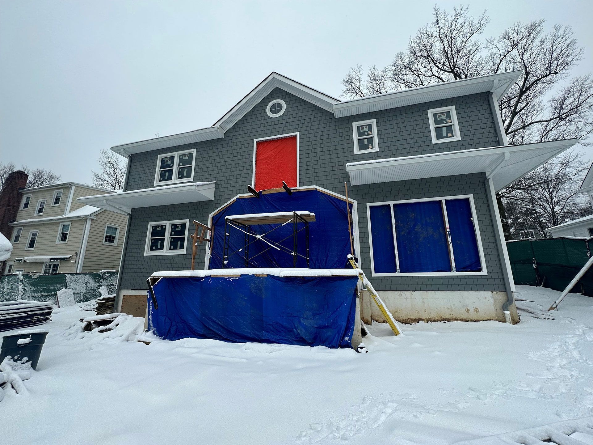 A large house is being built in the snow
