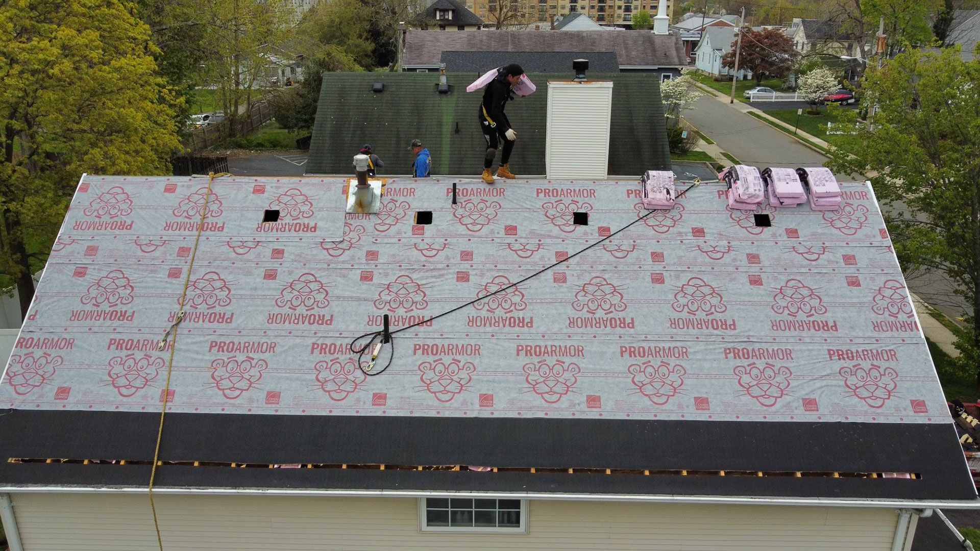 A man is working on the roof of a house