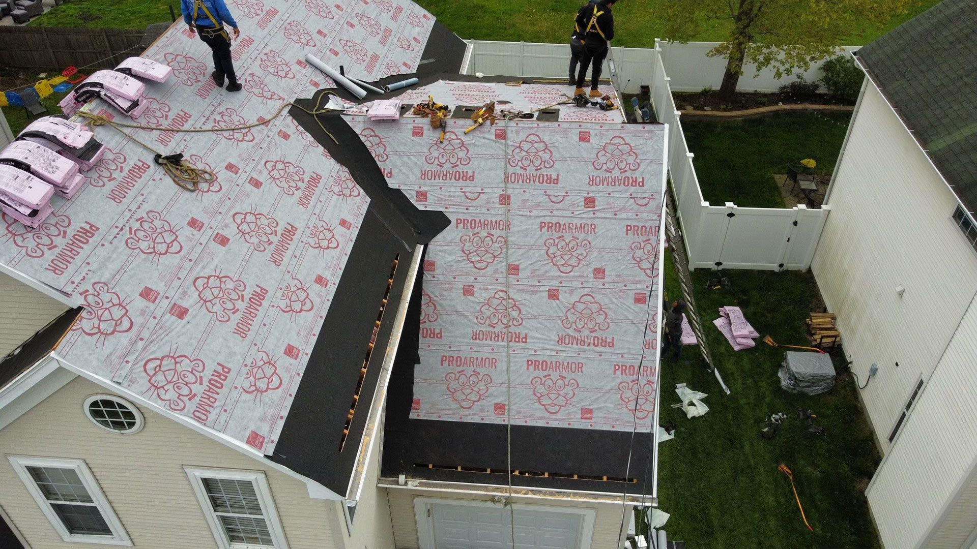 An aerial view of a roof being installed on a house.