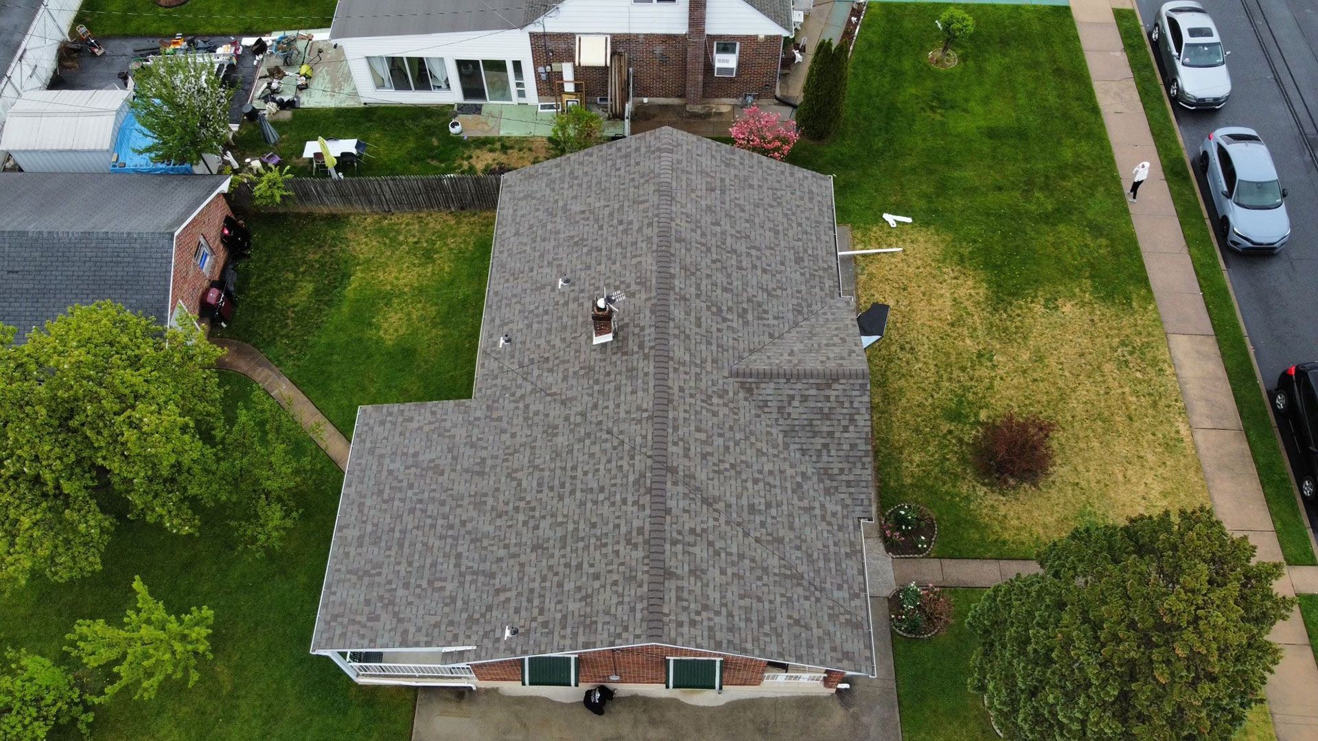 An aerial view of a house with a roof that is covered in shingles