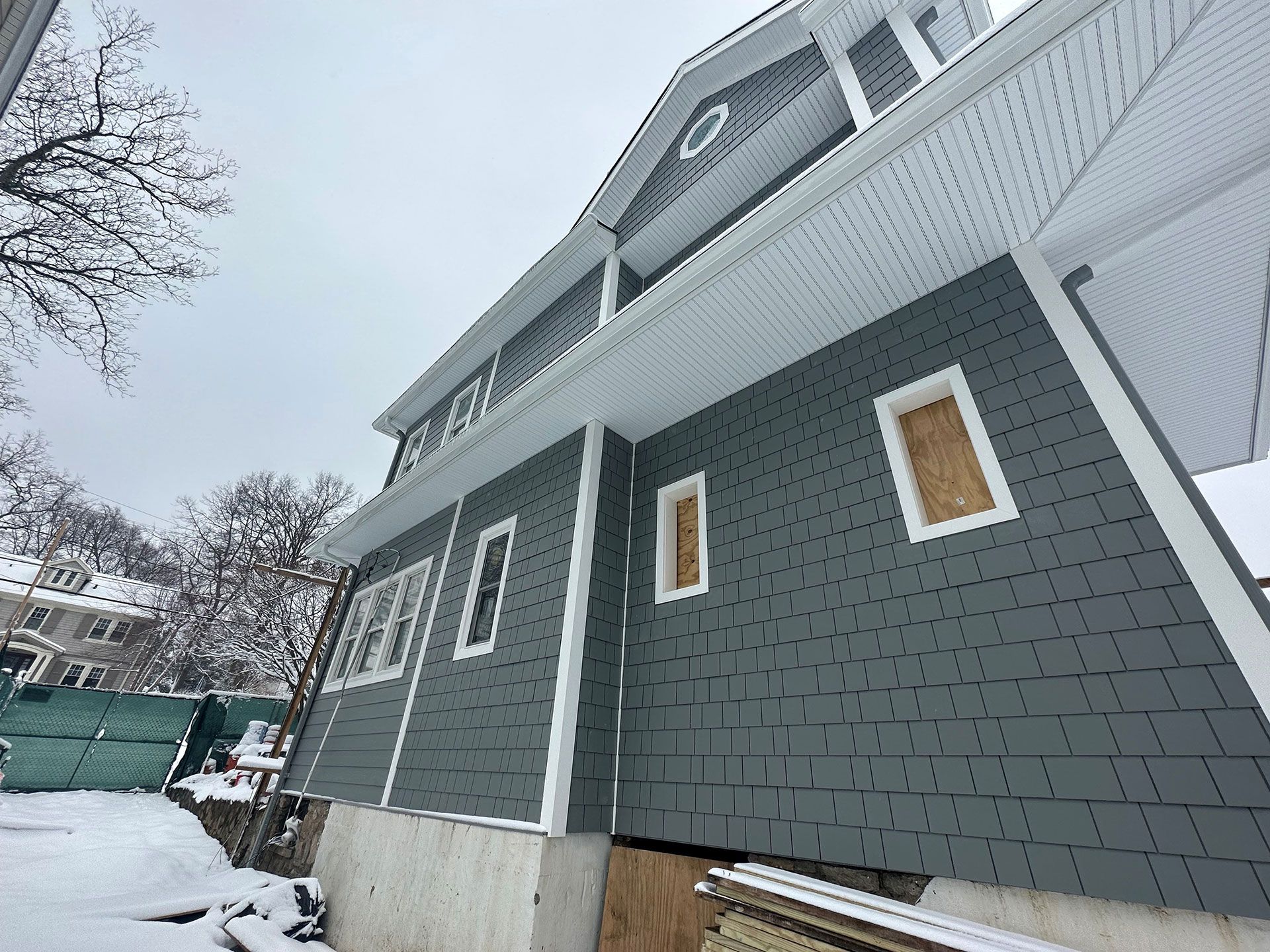 A large house is being built in the snow