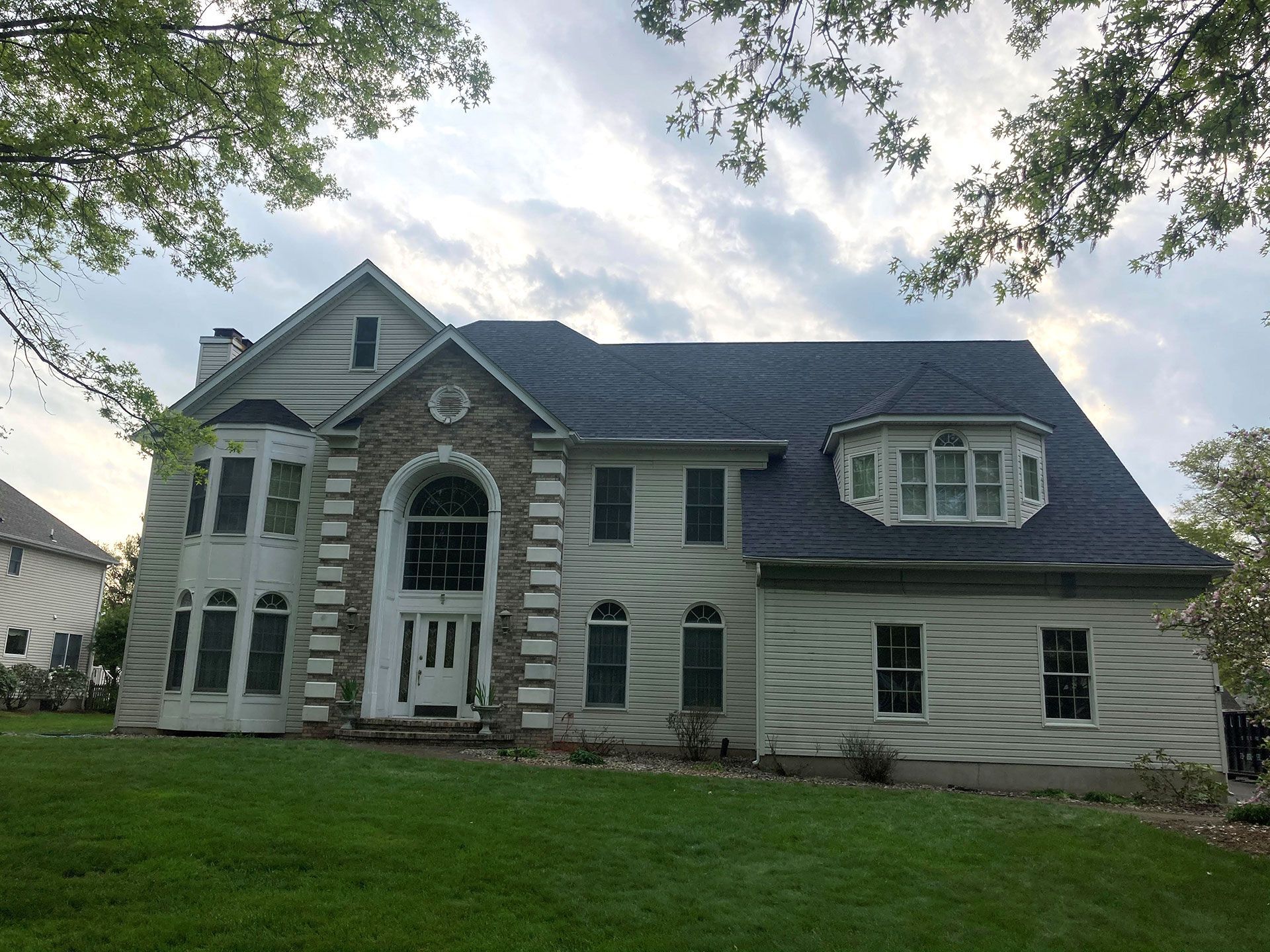 A large white house with a blue roof