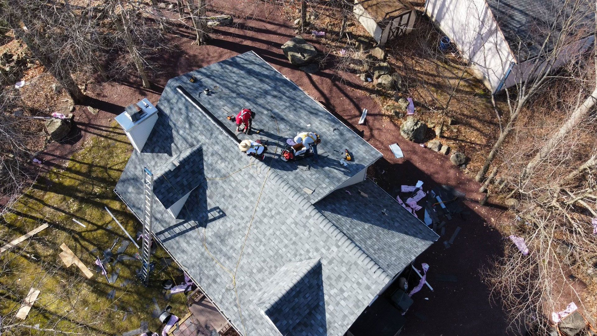 An aerial view of a roof being installed on a house