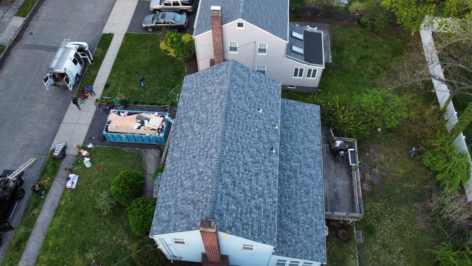 An aerial view of a house with a new roof being installed