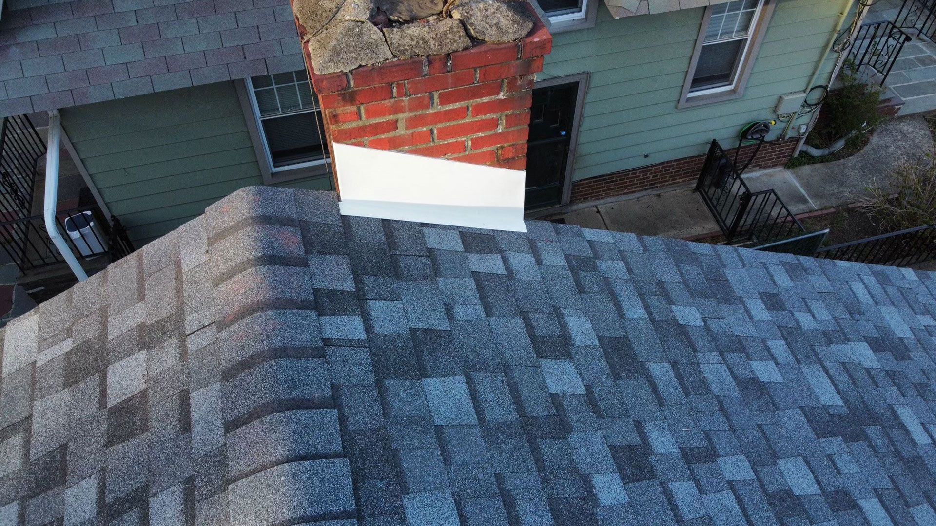 An aerial view of a roof with a chimney on top of it