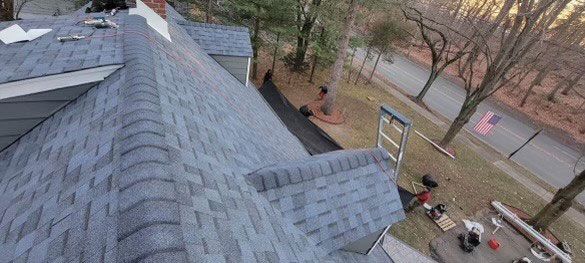 An aerial view of a roof being installed on a house.