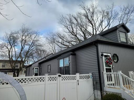 A mobile home with a white fence in front of it
