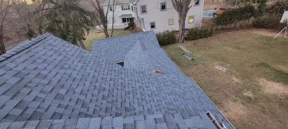 An aerial view of a house with a blue roof