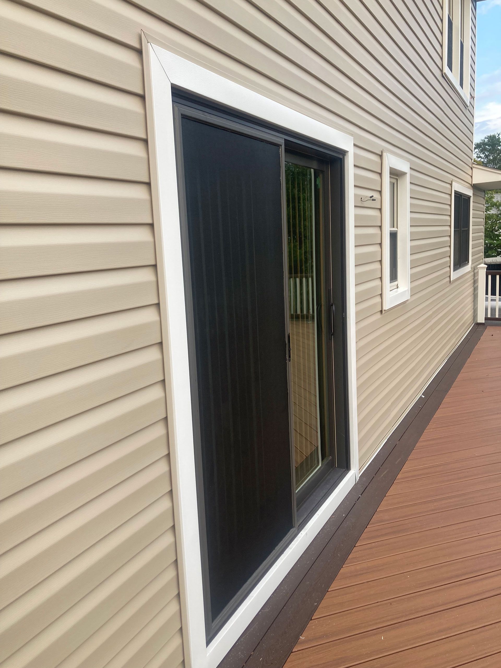 A house with a sliding glass door and a deck