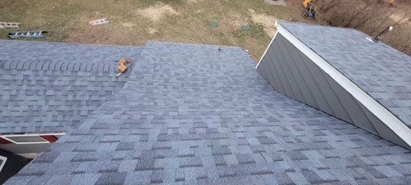 An aerial view of a roof being installed on a house