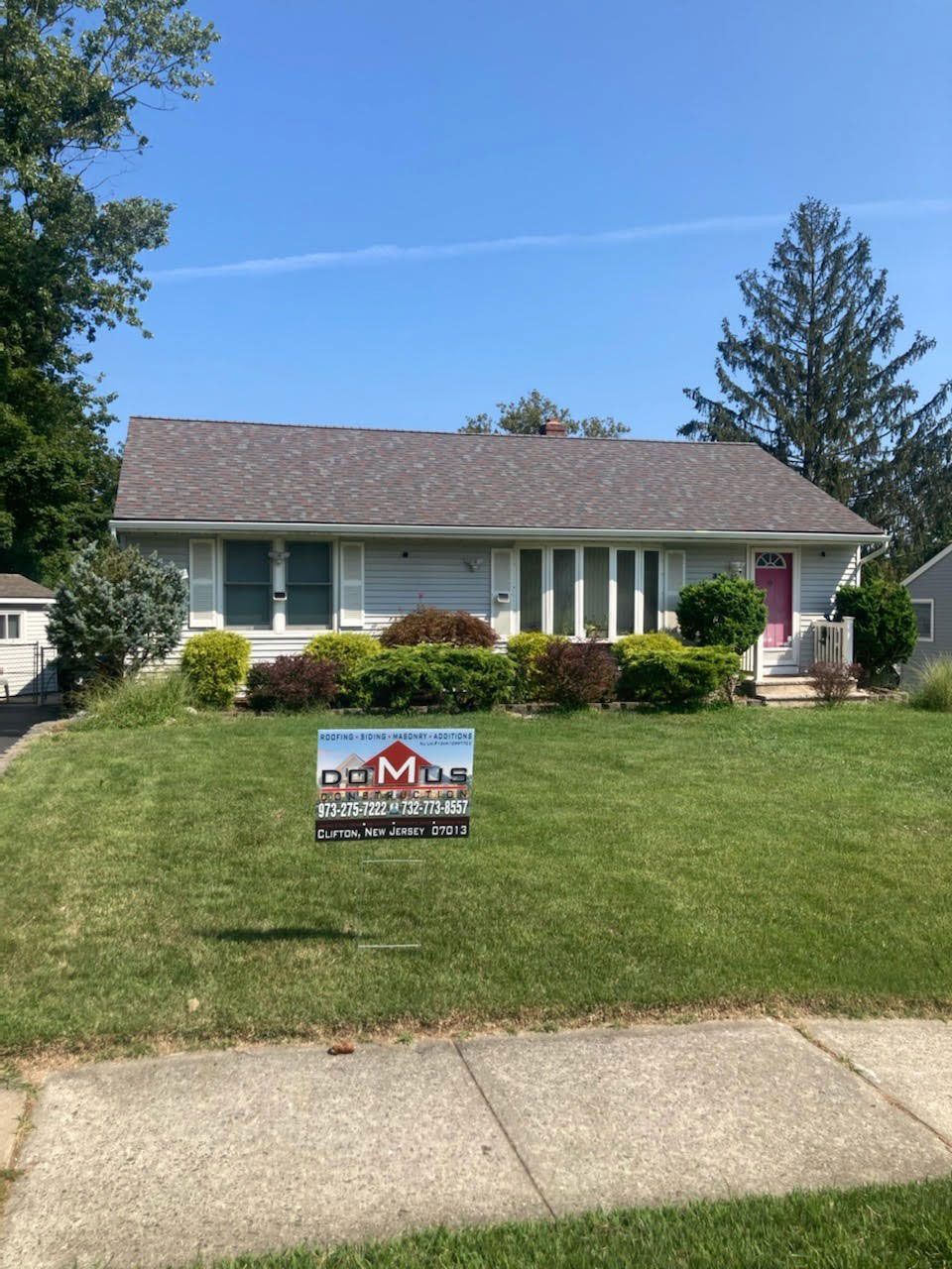 A house with a large lawn in front of it