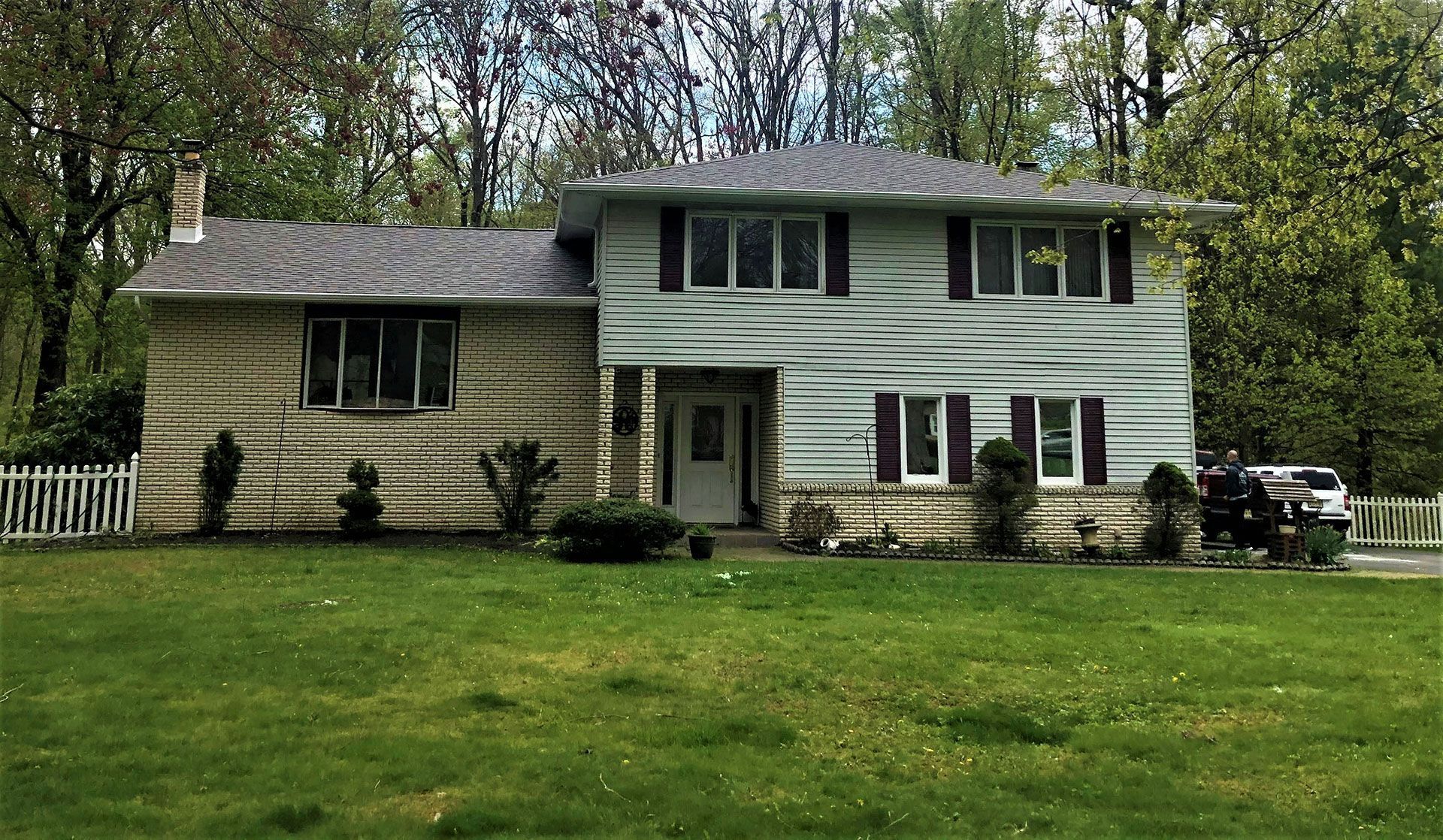 A house with a large lawn in front of it
