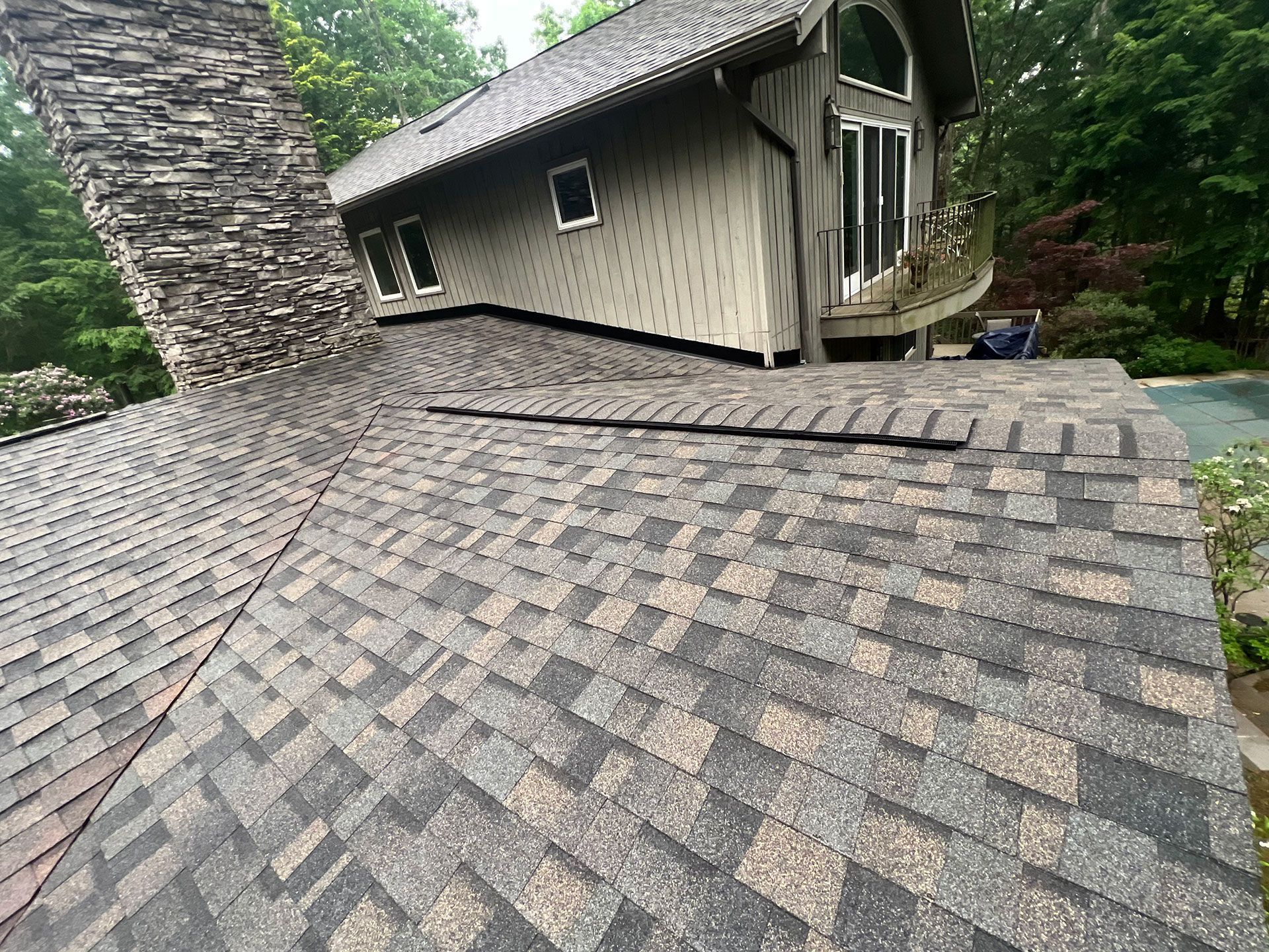 A house with a roof that is missing shingles and a chimney