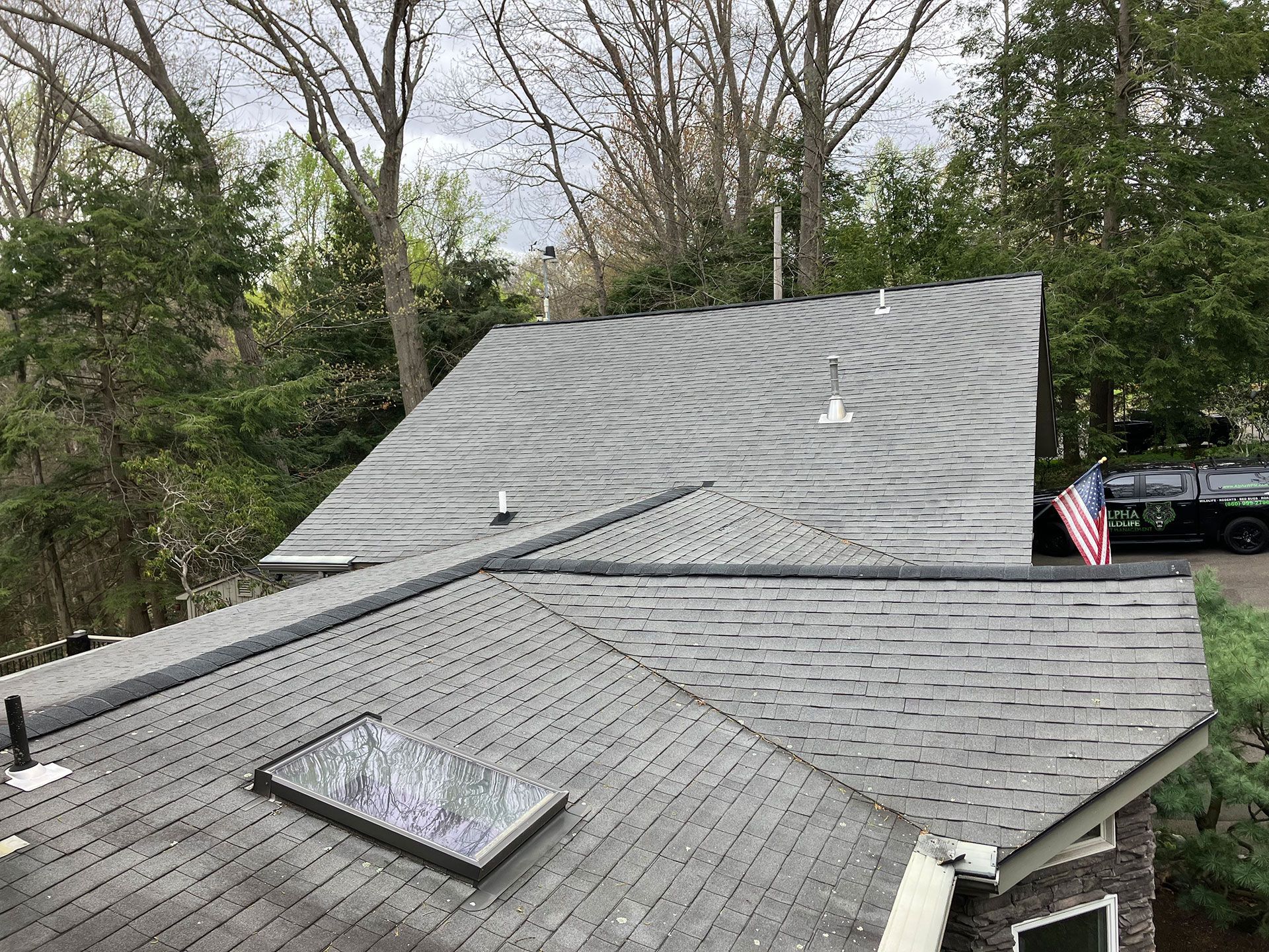 A roof with a skylight and an american flag on it