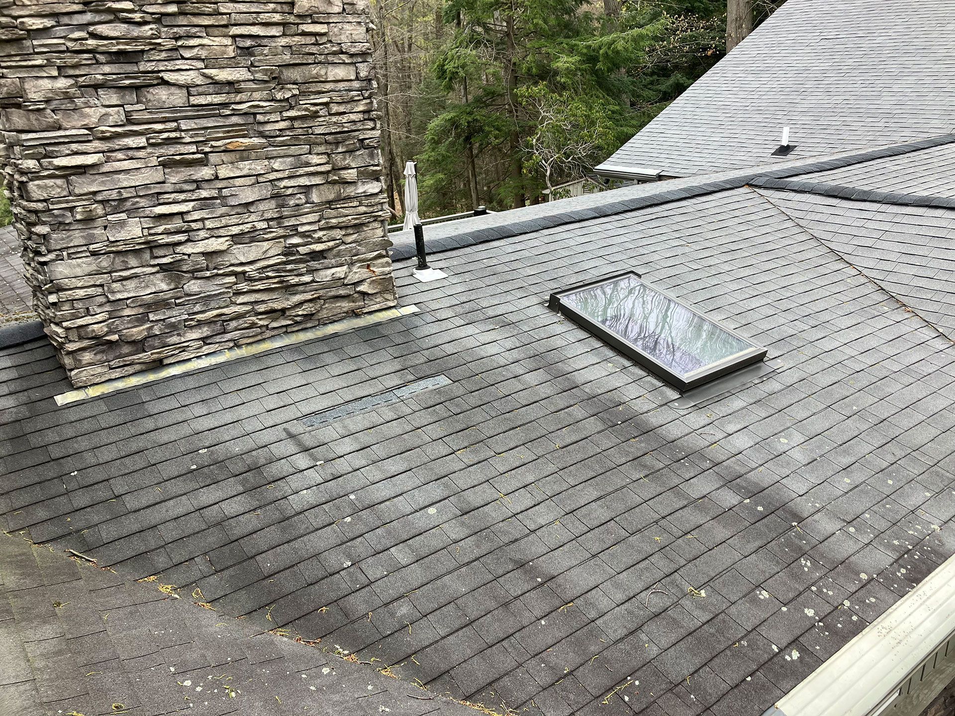 A roof with a skylight and a chimney on it