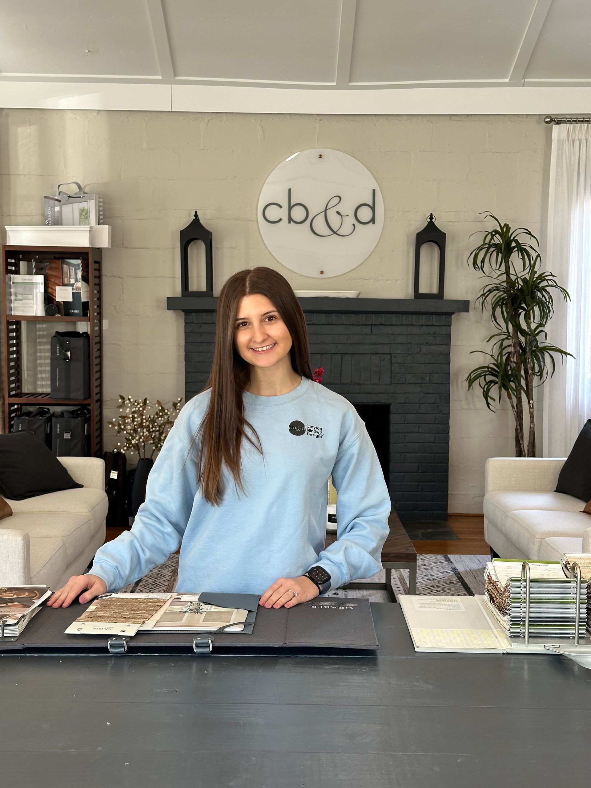 Man in white shirt and tan pants looks down at cardboard boxes outdoors.