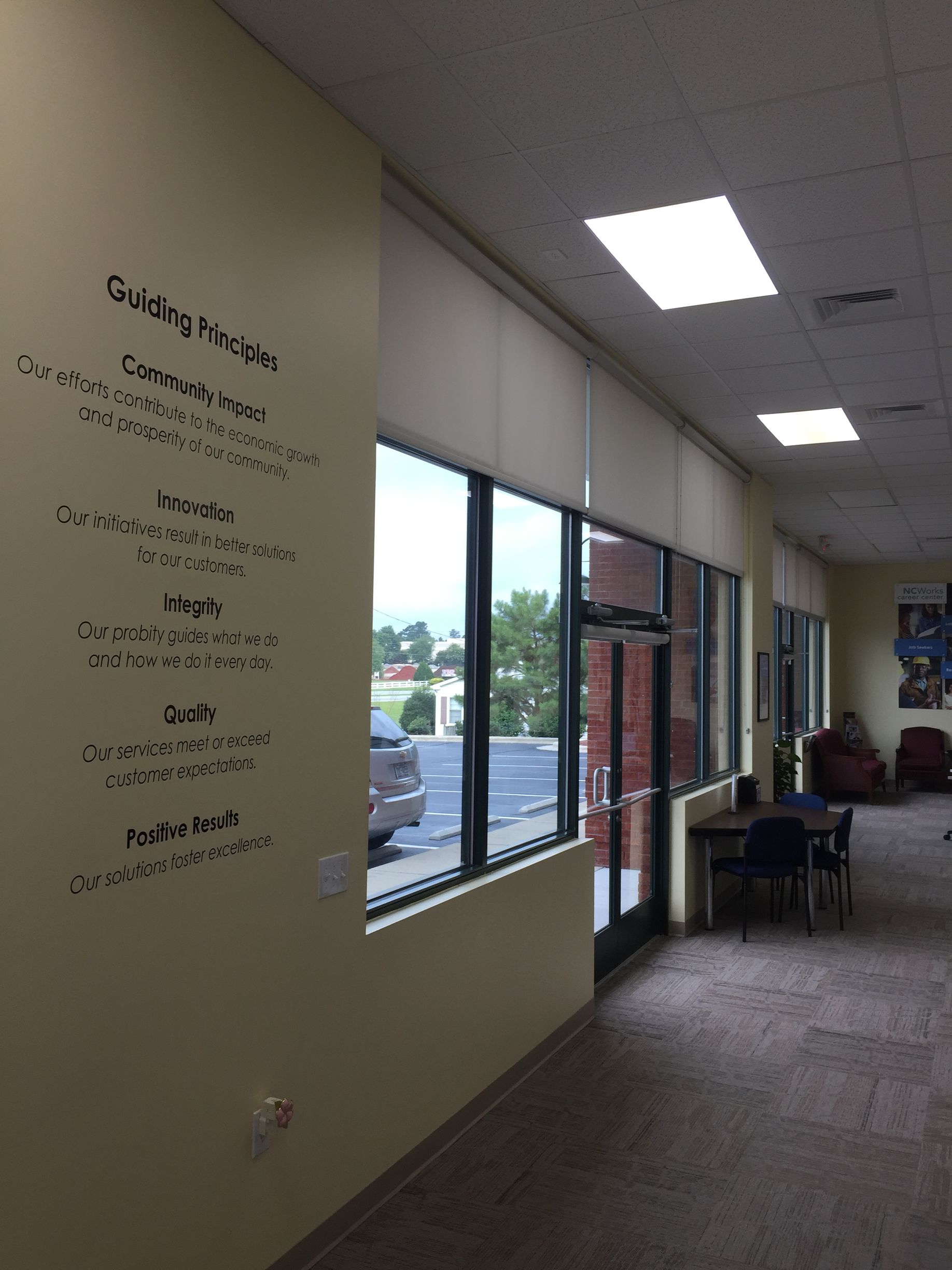 Hallway with windows, text on the wall: 