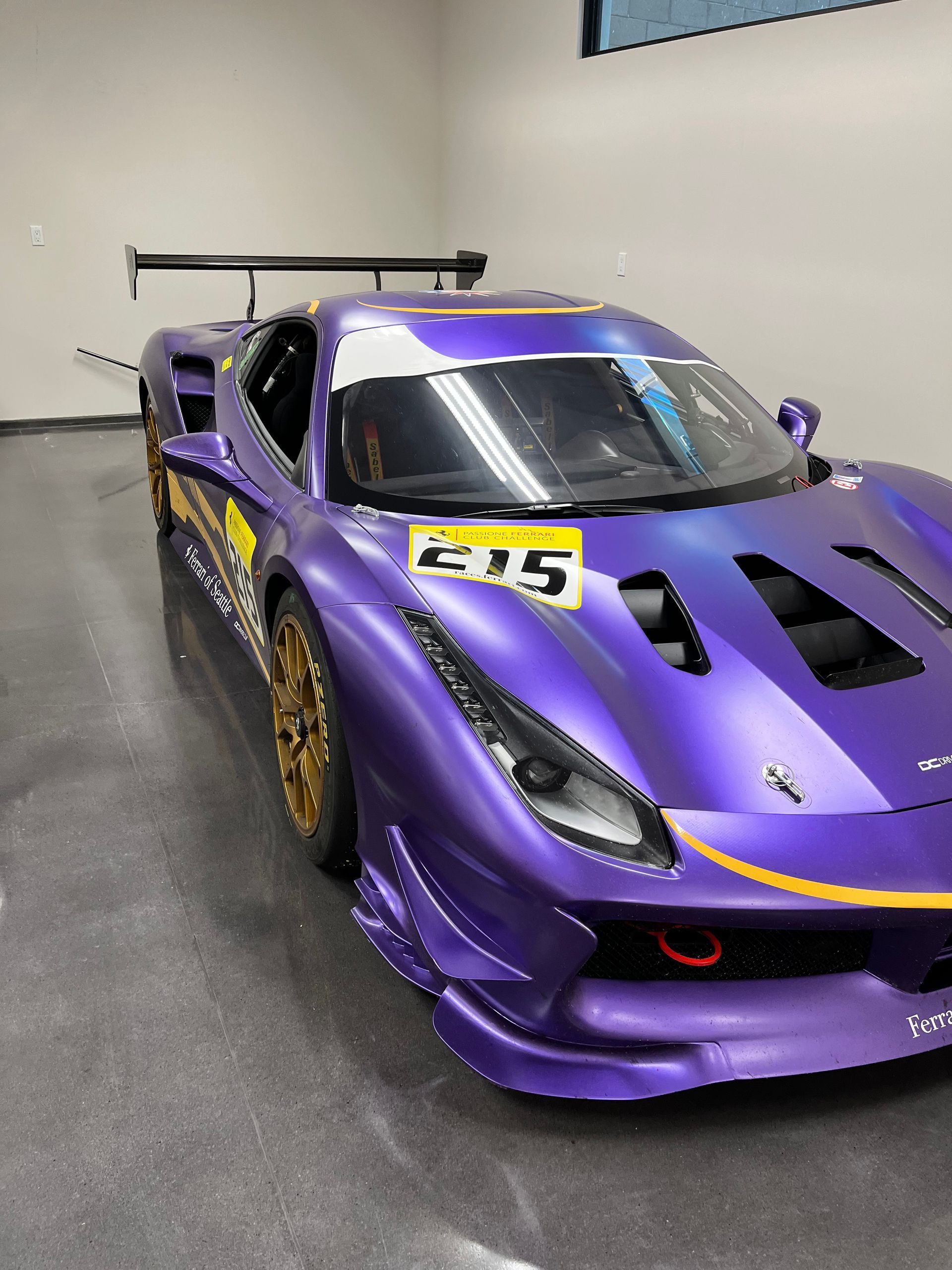 A purple sports car with the number 215 on it
