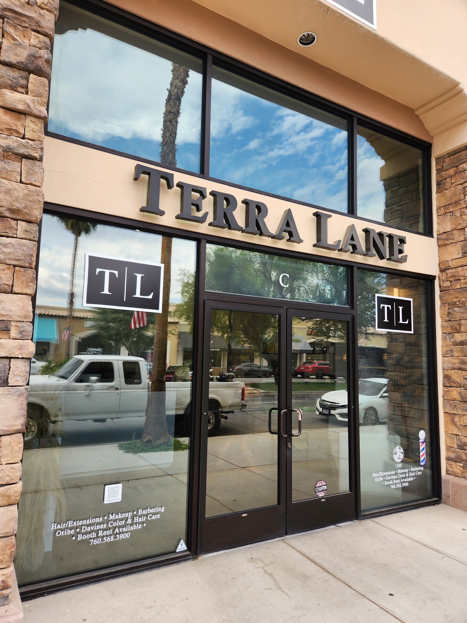 A terra lane storefront with a truck parked in front of it