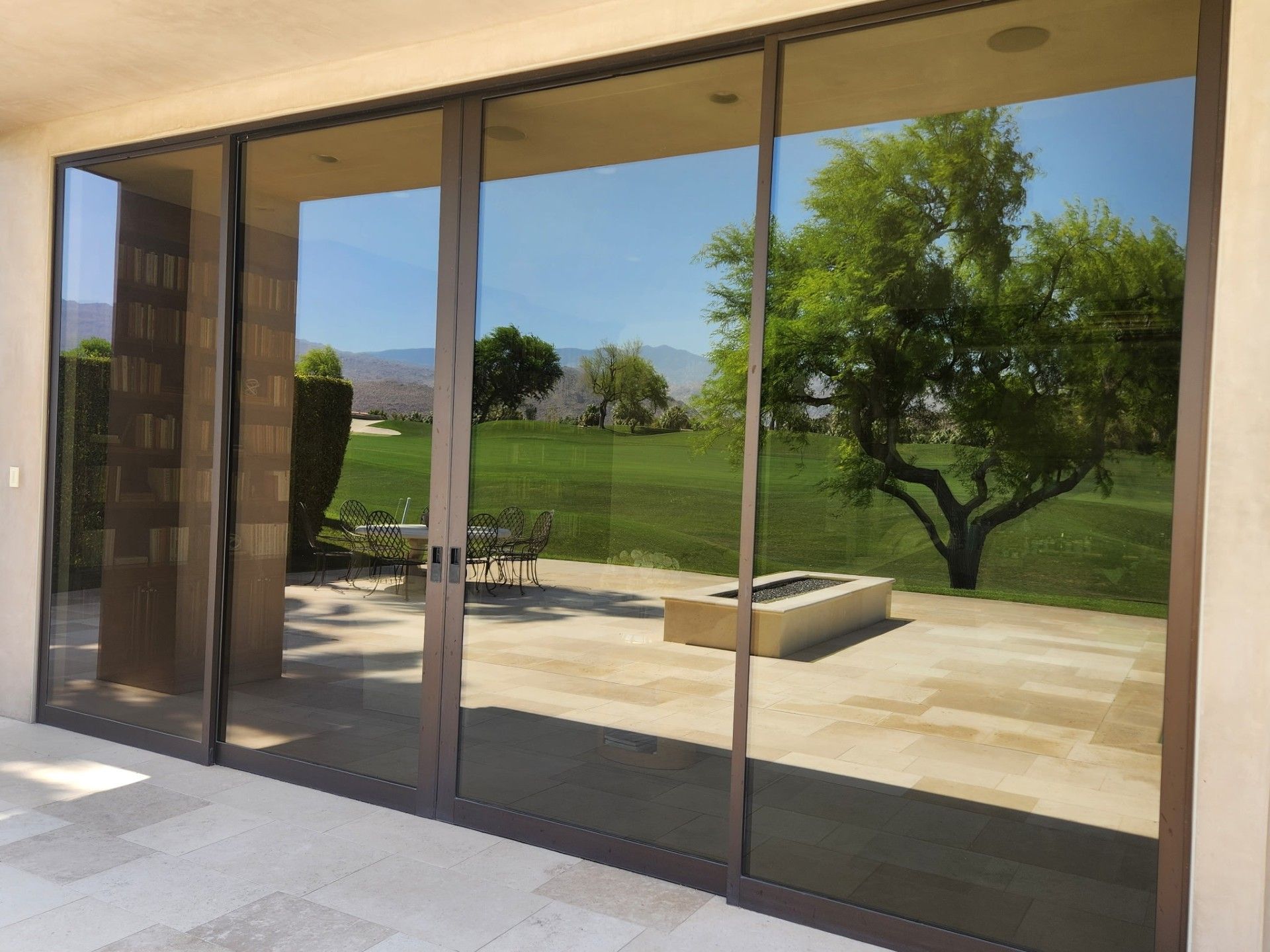 A sliding glass door with a view of a golf course