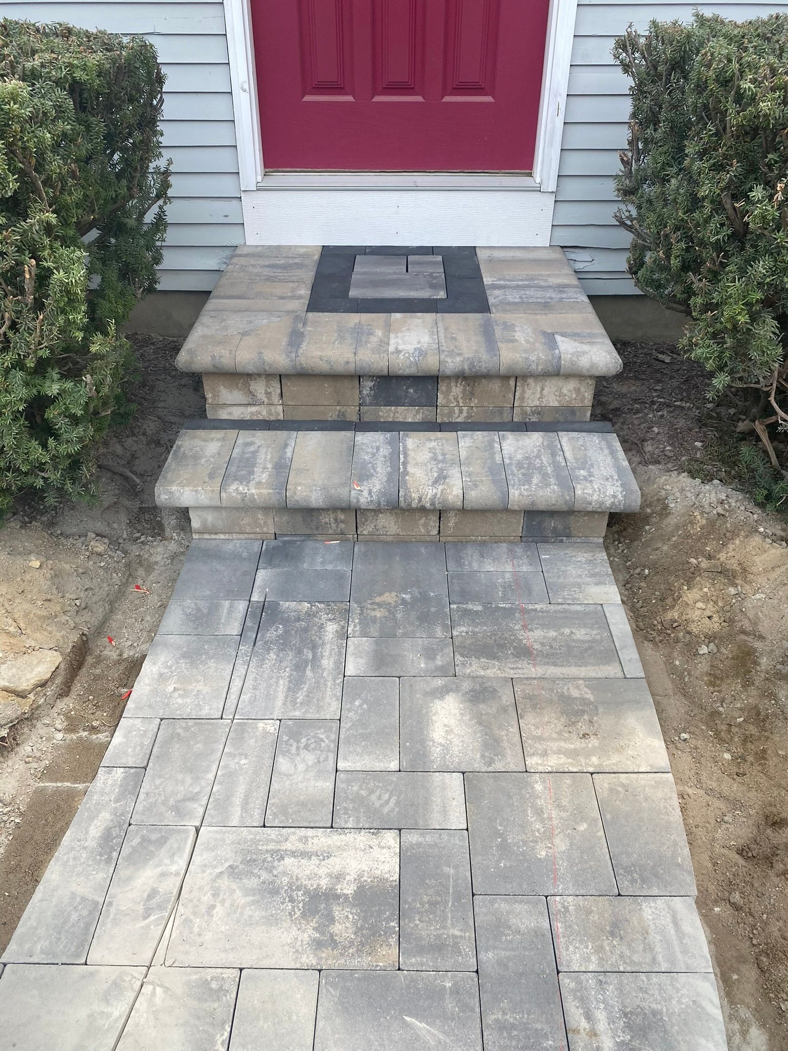 hardscape walkway to a red door