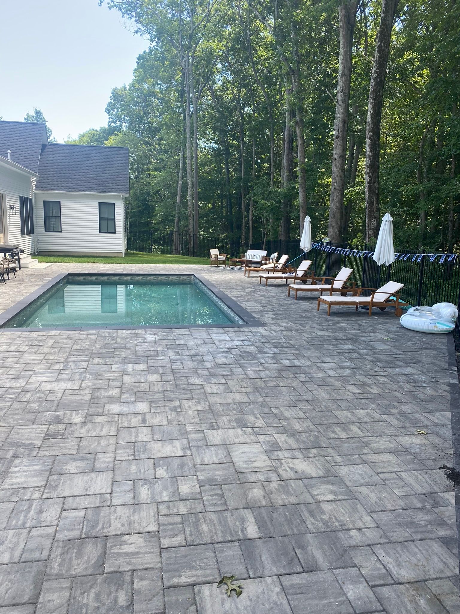 gray pool deck with rectangular pool
