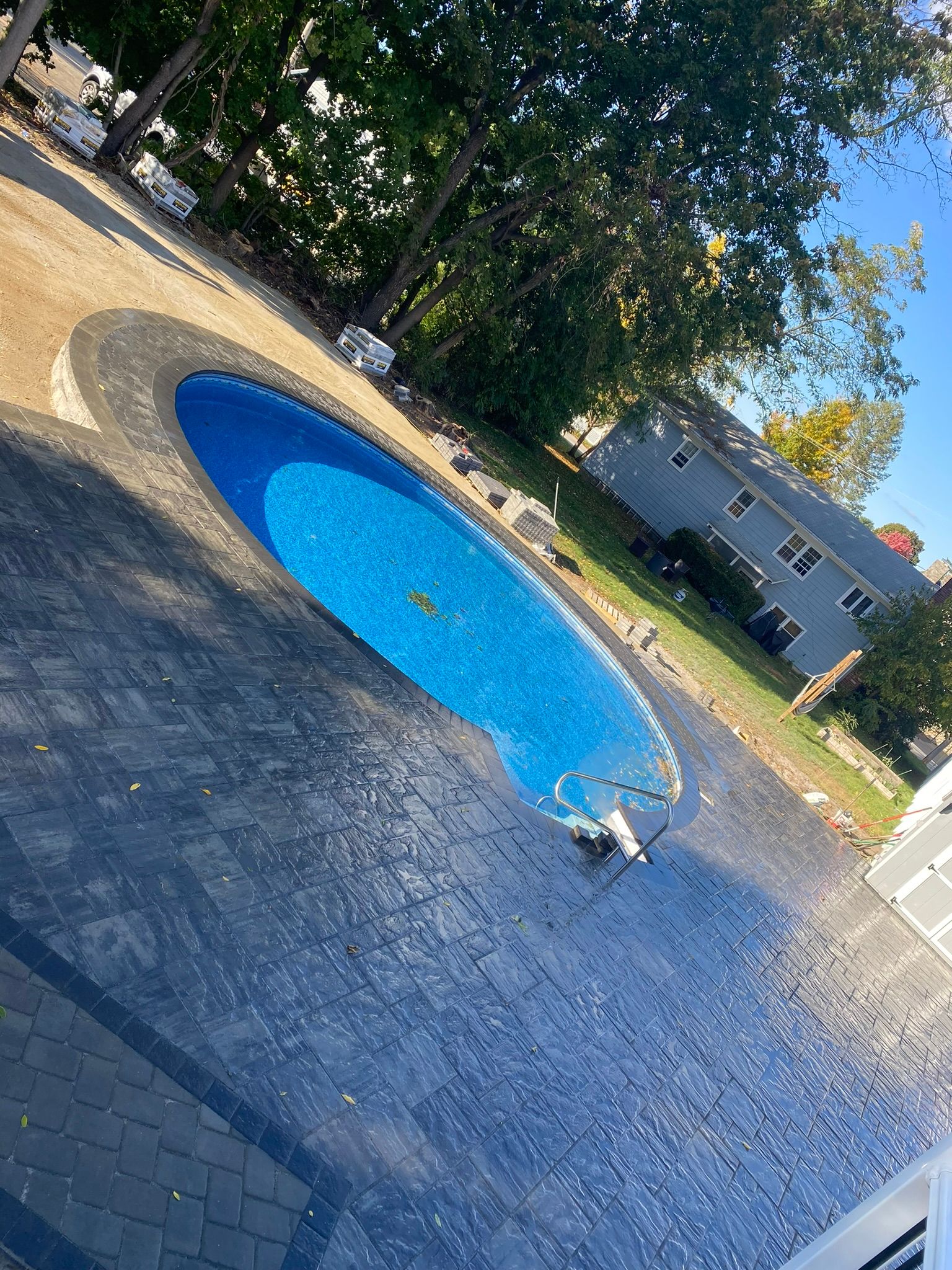 top view of a circular pool with stoned deck