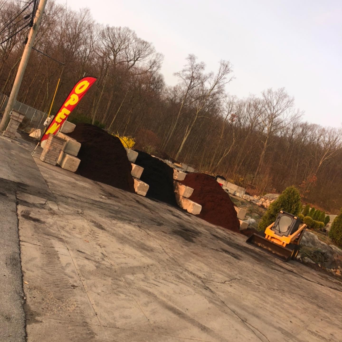 A supplier yard with piles of mulch, blocks for separation, an