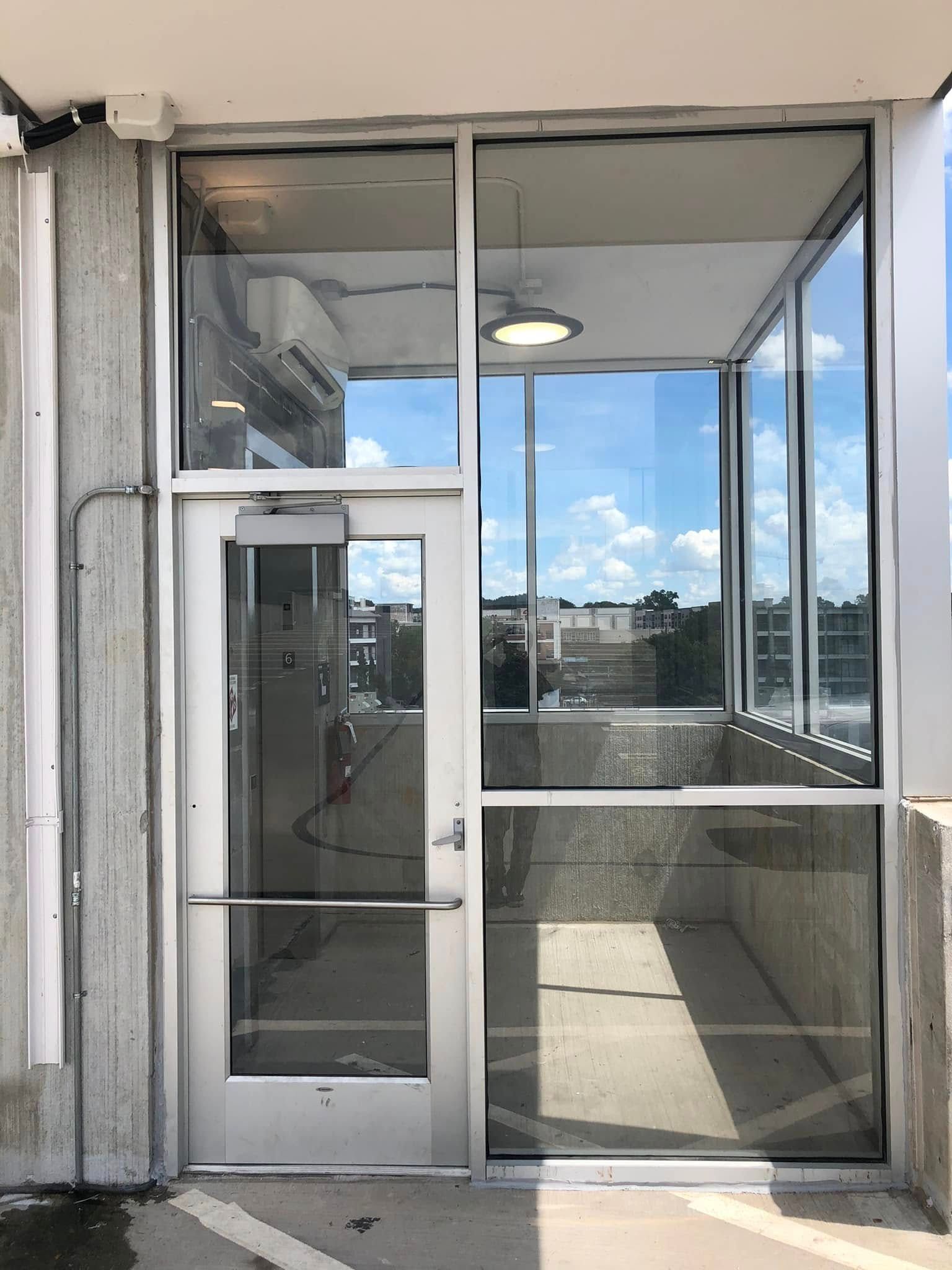 A large glass door with a lot of windows on a building.