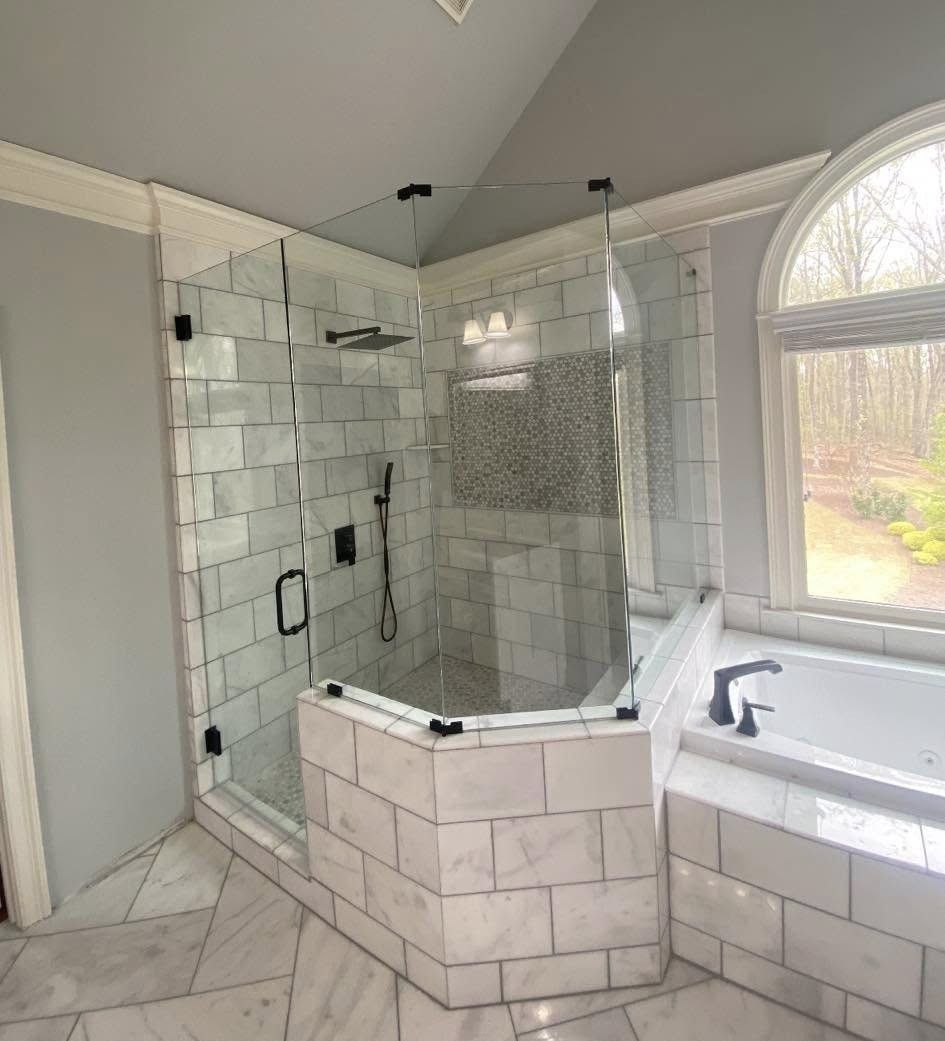 A bathroom with a tub , shower , and window.